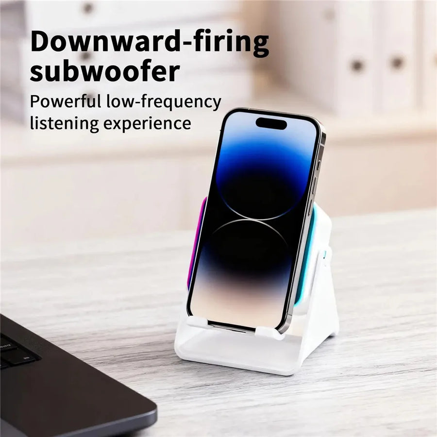 Phone dock with downward-firing subwoofer on a desk with text overlay
