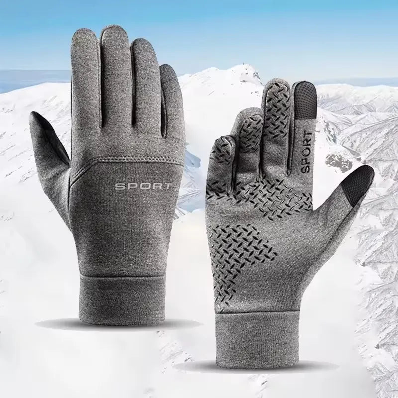Gray winter touchscreen gloves with SPORT branding and textured non-slip palm, shown against a snowy mountain background