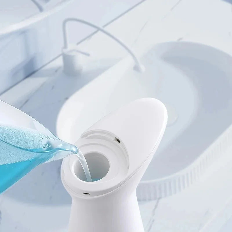Blue liquid being poured into a white container with a marble countertop background