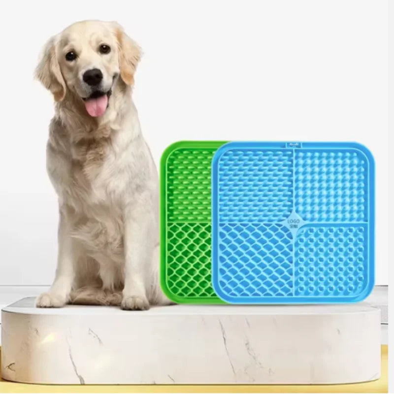 Dog sitting next to two pet training pads, one green and one blue, on a white background.