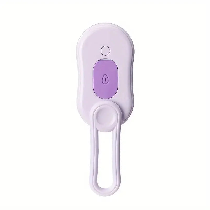 Close-up of the purple and white pet steam brush button on white background – 3-in-1 deshedding grooming comb with steam spray