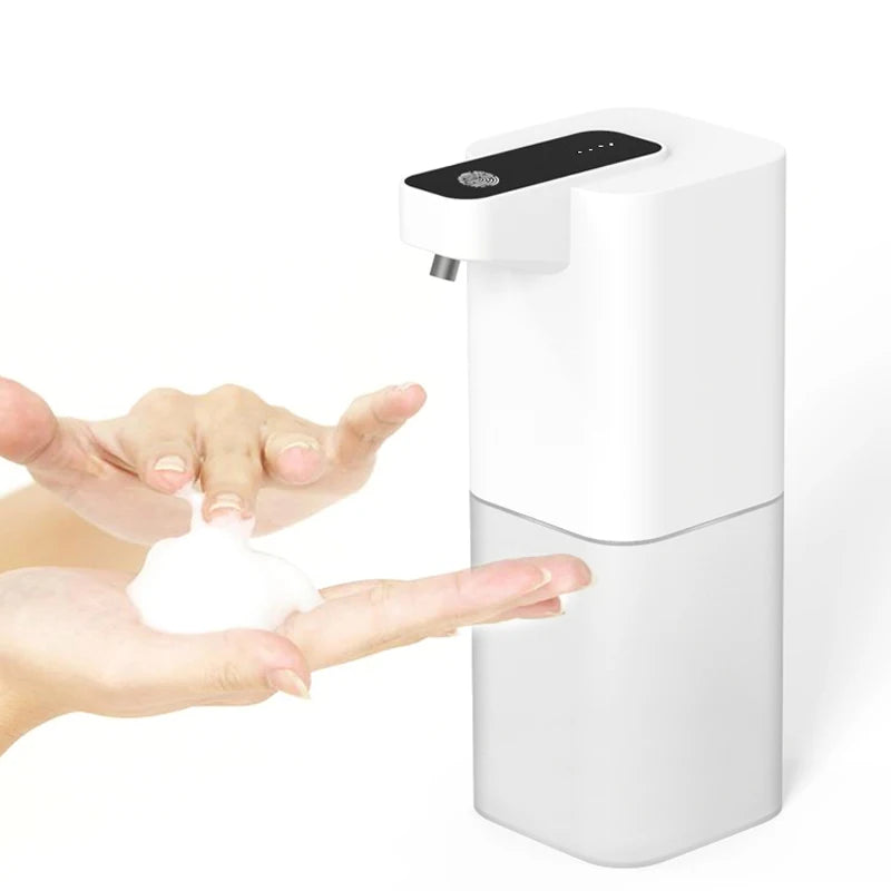 White touchless hand soap dispenser with hands using it on a white background