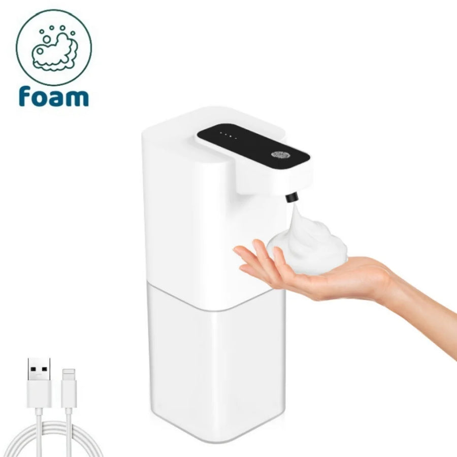 White foam soap dispenser with a hand reaching out to dispense soap, USB cable on the side.
