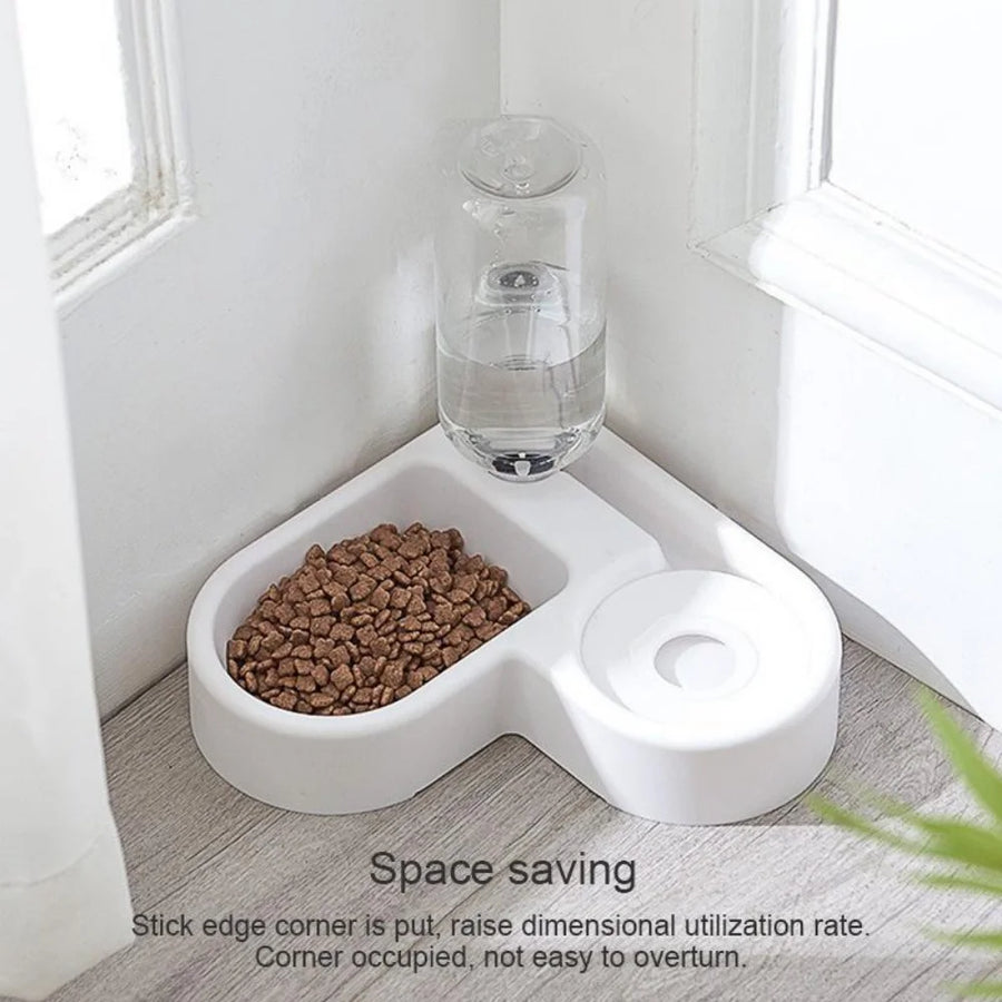 White pet feeder with a bowl of food and a water bottle on a wooden floor.