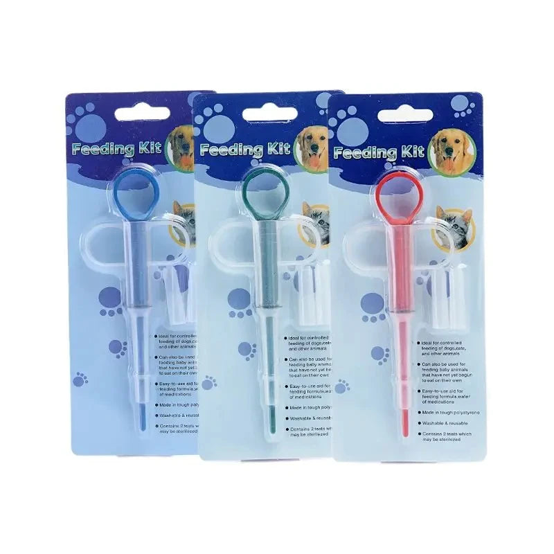 Three pet pill feeder kit packages with different colored soft tips on white background