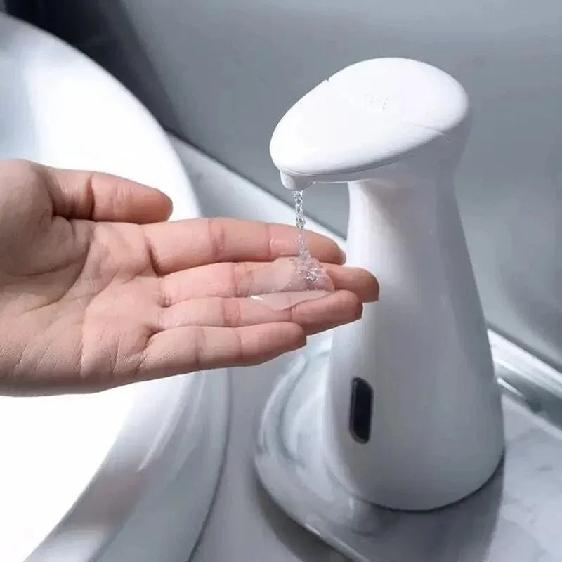 Hand pressing a white soap dispenser to release liquid soap.