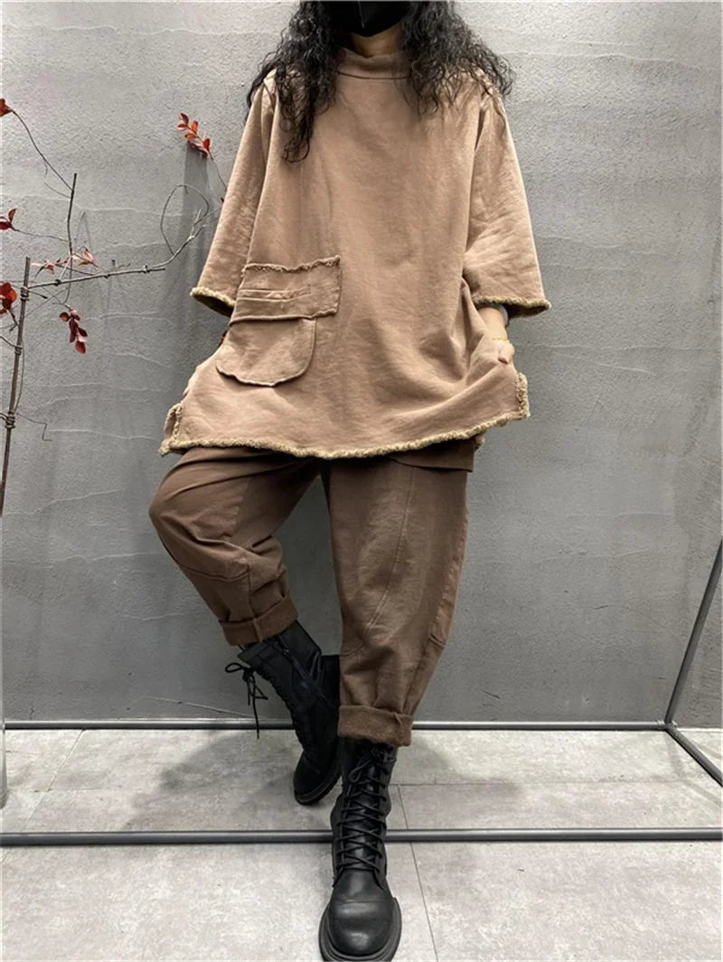 Womens plus size long sleeve top in light coffee, loose fit casual t-shirt with black boots against gray wall