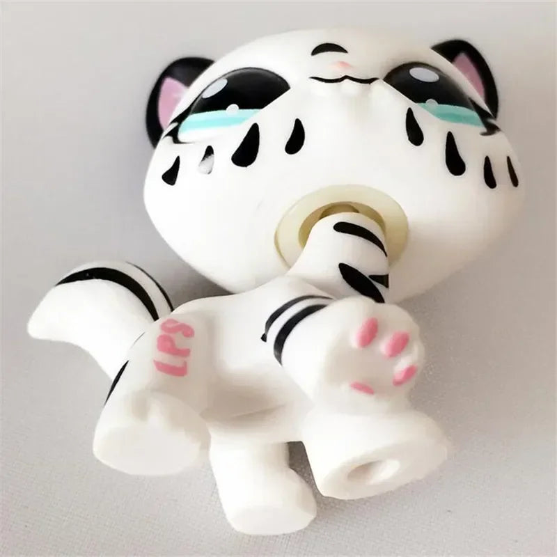 Mini pet shop kitty figure – white with black stripes and pink paw pads, lying on its back