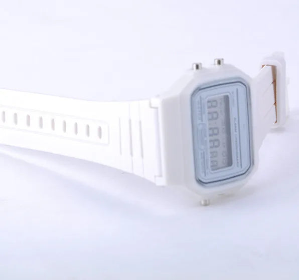 Men's white LED digital military watch with white silicone band on light gray background, vintage digital wristwatch.