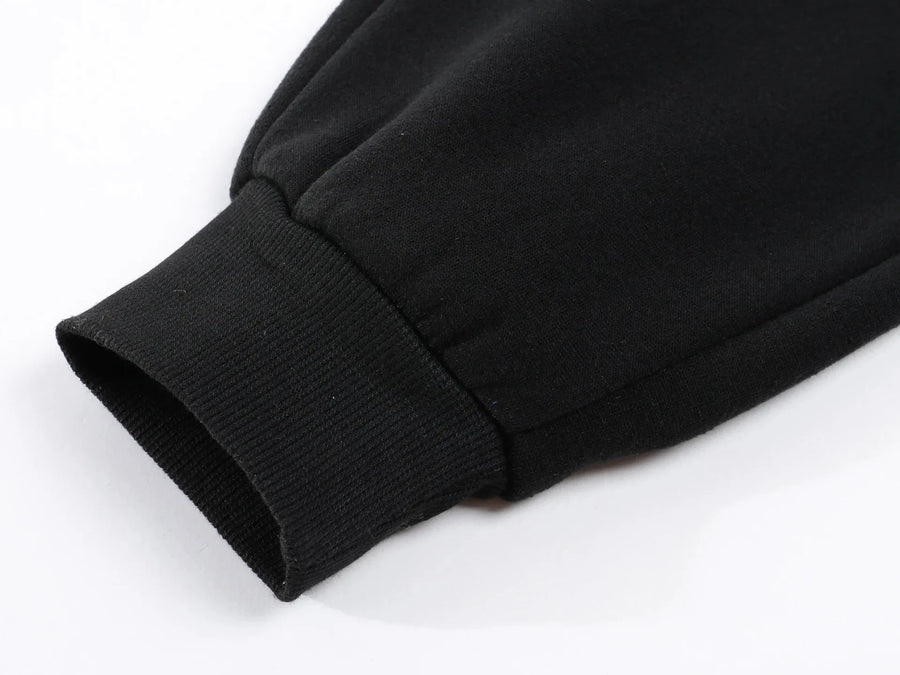Mens fleece lined jogger sweatpants – close-up of black sweatshirt sleeve on white background