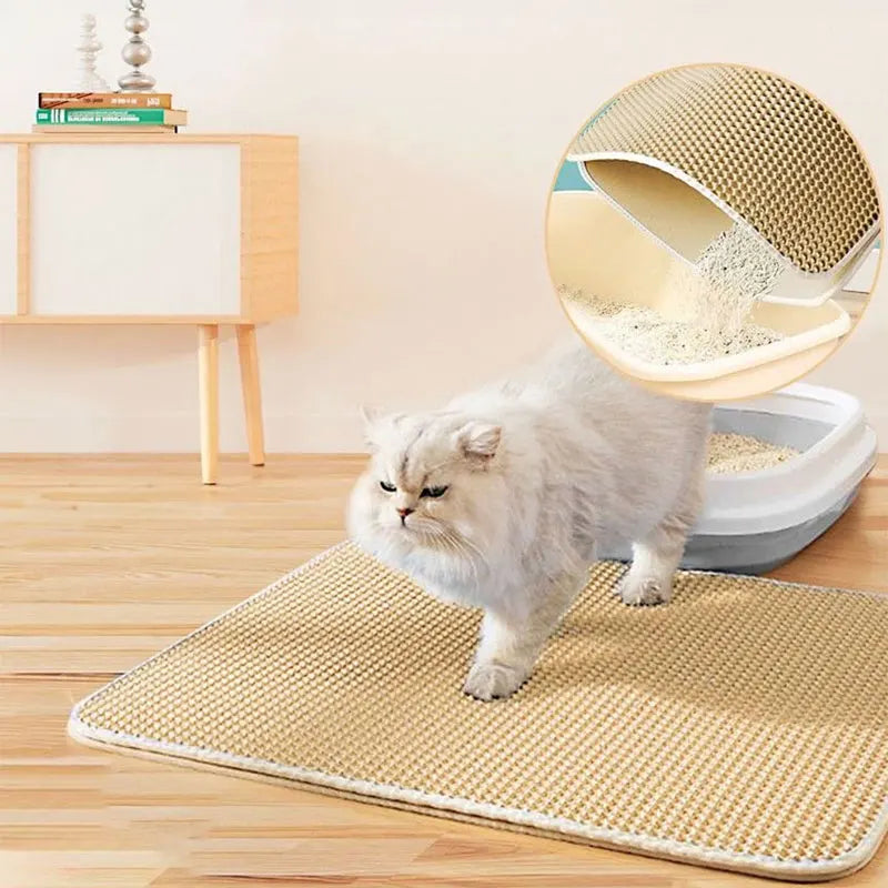 Cat walking across a double-layer cat litter trapping mat with a litter box and cat tree behind