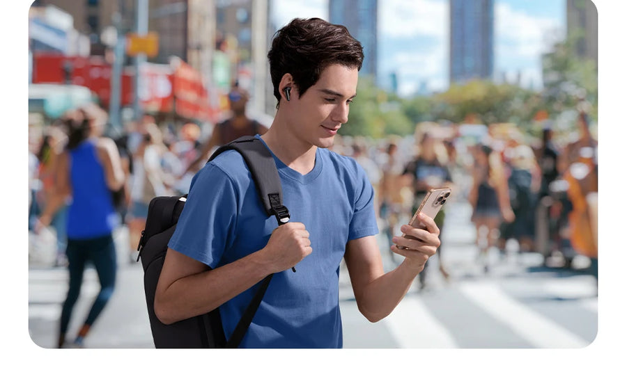 Man using smartphone on busy city street – wireless earbuds, 6-mic AI ENC clear calls