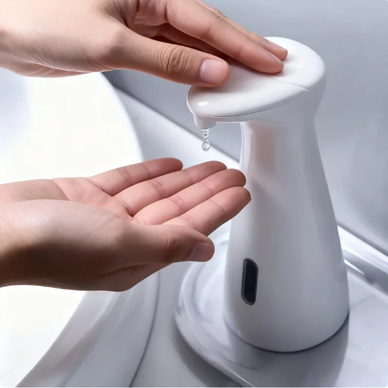 Hand pressing a white soap dispenser to dispense liquid soap.