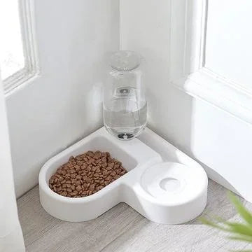 Pet food bowl with water dispenser on a light wood floor.