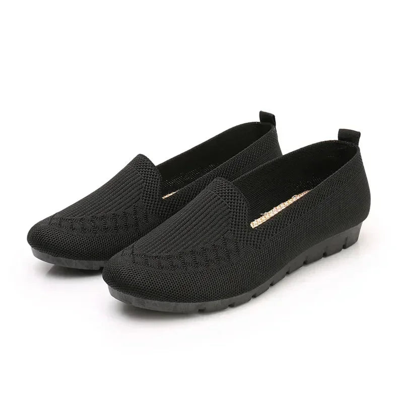 Pair of black loafers on a white background