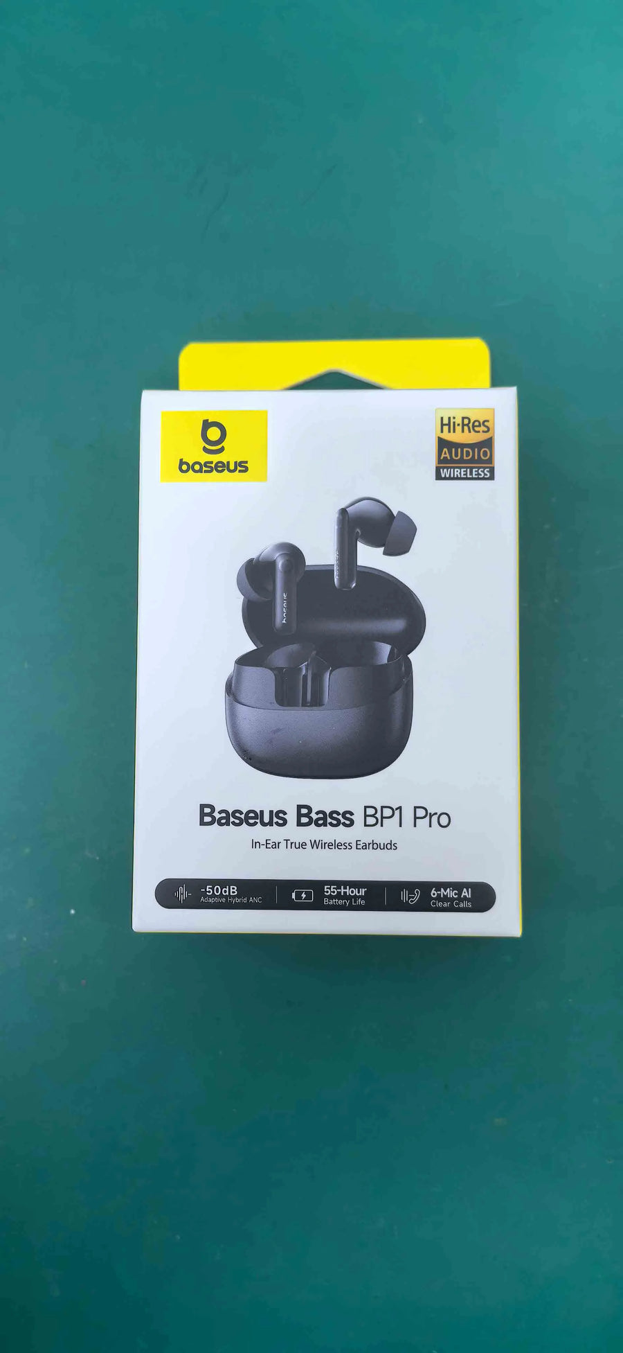 Baseus Bass BPI Pro wireless earbuds packaging on a green background