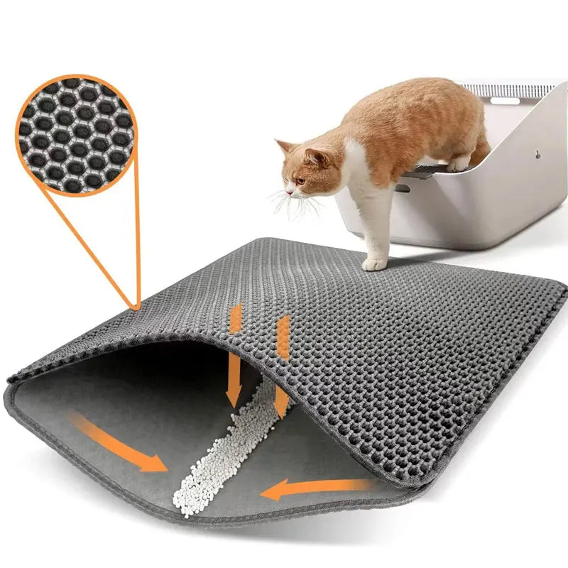Gray honeycomb double-layer cat litter mat with a cat sniffing and inspecting it, white background product photo