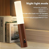 Wood grain magnetic motion sensor night light glowing warm on a wooden shelf