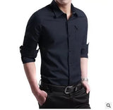 Men's black casual button-down shirt with rolled-up sleeves, worn by a model