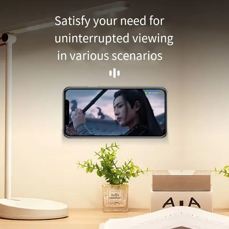 Table lamp with smartphone displaying a scene, text 'Satisfy your need for uninterrupted viewing in various scenarios', indoor setting.