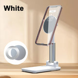 White foldable MagSafe phone stand holding a smartphone on a wooden surface.