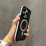 Hand holding a black phone case with Apple logo against a gray background