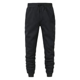 Men's black jogger sweatpants with elastic waistband and side pockets on white background