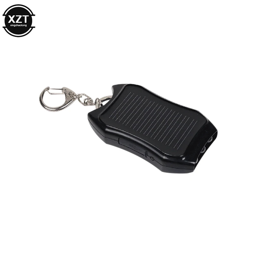 Black keychain device with solar panel on a white background, featuring the brand 'XZT'.