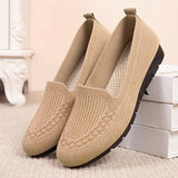 Pair of beige slip-on shoes on a light background