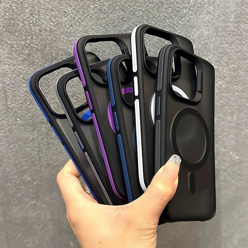 Hand holding multiple black MagSafe phone cases with colored accents fanned out on a gray background.