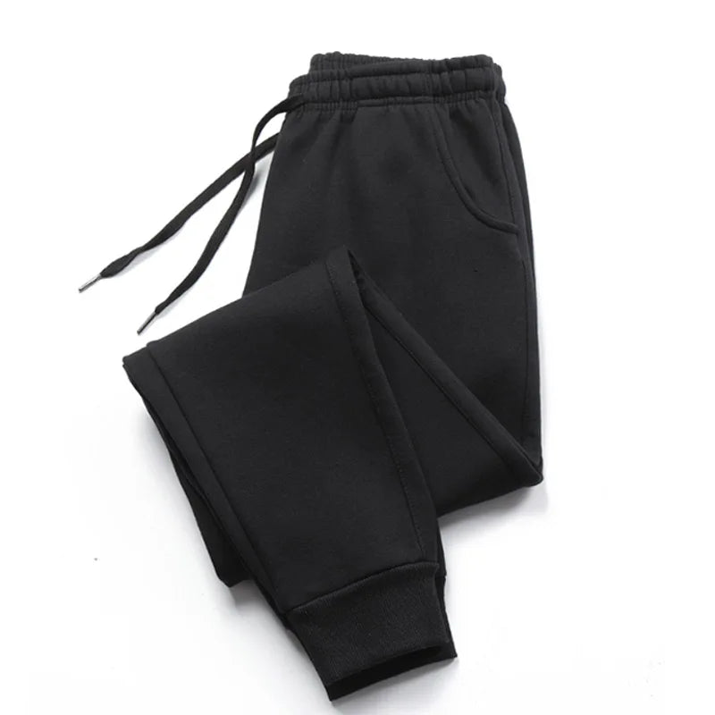Men's black jogger sweatpants with cuffed ankles on white background