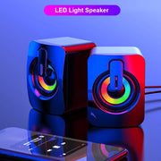 USB wired computer speakers with LED light beside a smartphone, showcasing vibrant LED lighting and modern design.
