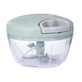 Manual vegetable chopper with sage green lid and clear bowl showing blade assembly