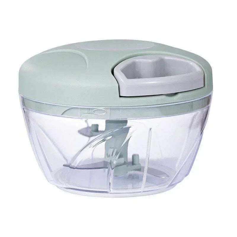 Manual vegetable chopper with sage green lid and clear bowl showing blade assembly