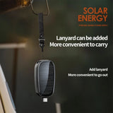Solar energy portable power supply with lanyard attachment on a blurred background