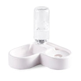 Clear glass bottle with white ceramic holder on a white background