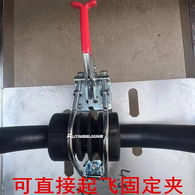 A close-up of a metal clamp tool with a red handle, mounted over a black cylindrical bar. The clamp has visible branding text reading 'RUTINGXUAKING' and Chinese text overlaid at the bottom.