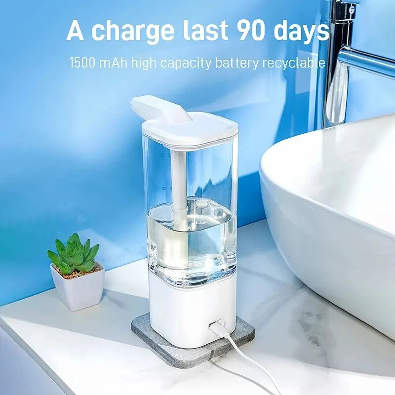 Rechargeable automatic hand sanitizer dispenser with 1500mAh battery lasting up to 90 days per charge, on USB charging base beside a sink