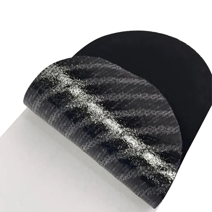 Close-up of black anti-snoring mouth tape strip showing breathable fabric texture