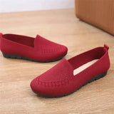 Red loafers on a wooden floor