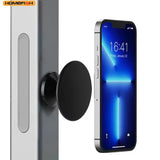 A black magnetic phone mount shown attached to a silver door frame, with a smartphone displayed beside it to demonstrate use. The brand name HOMEFISH appears in the top-left corner.