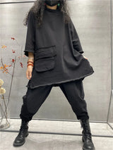 Womens plus size long sleeve top in black, loose fit casual t-shirt worn with pants and boots