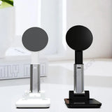 Two black and white electronic devices on a white surface with a blurred background.