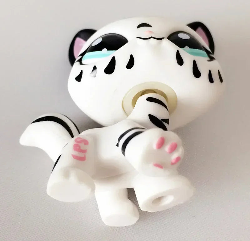 Mini pet shop tiger figure – white with black stripes and pink paw pads, lying on its back