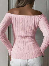 Back view of model wearing pink off-shoulder cable-knit sweater, showing the knit texture