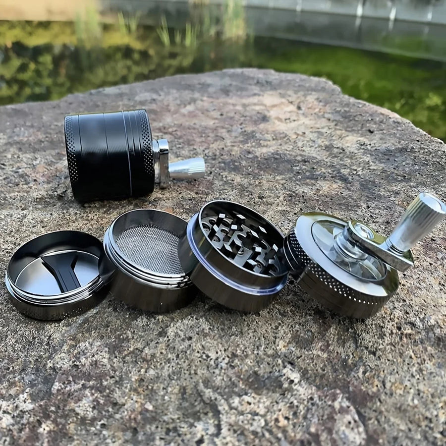 Black metal grinder on a stone surface with a blurred natural background