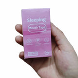 Hand holding pink Sleeping Mouth Tape box — anti-snoring mouth strips for sleeping, 30 pcs
