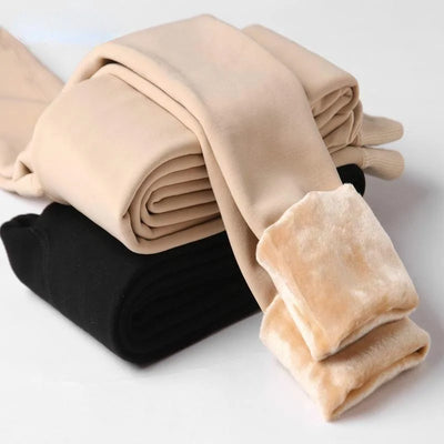 Folded beige and black leggings on a light gray background