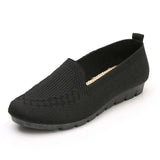 Black slip-on shoe with a white background