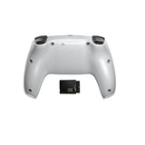 Silver gaming controller with a small black device on a white background